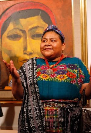 Rigoberta Menchu with portait by Oswaldo Guayasamin